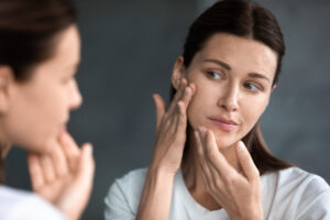 Woman in mirror worried about wrinkles